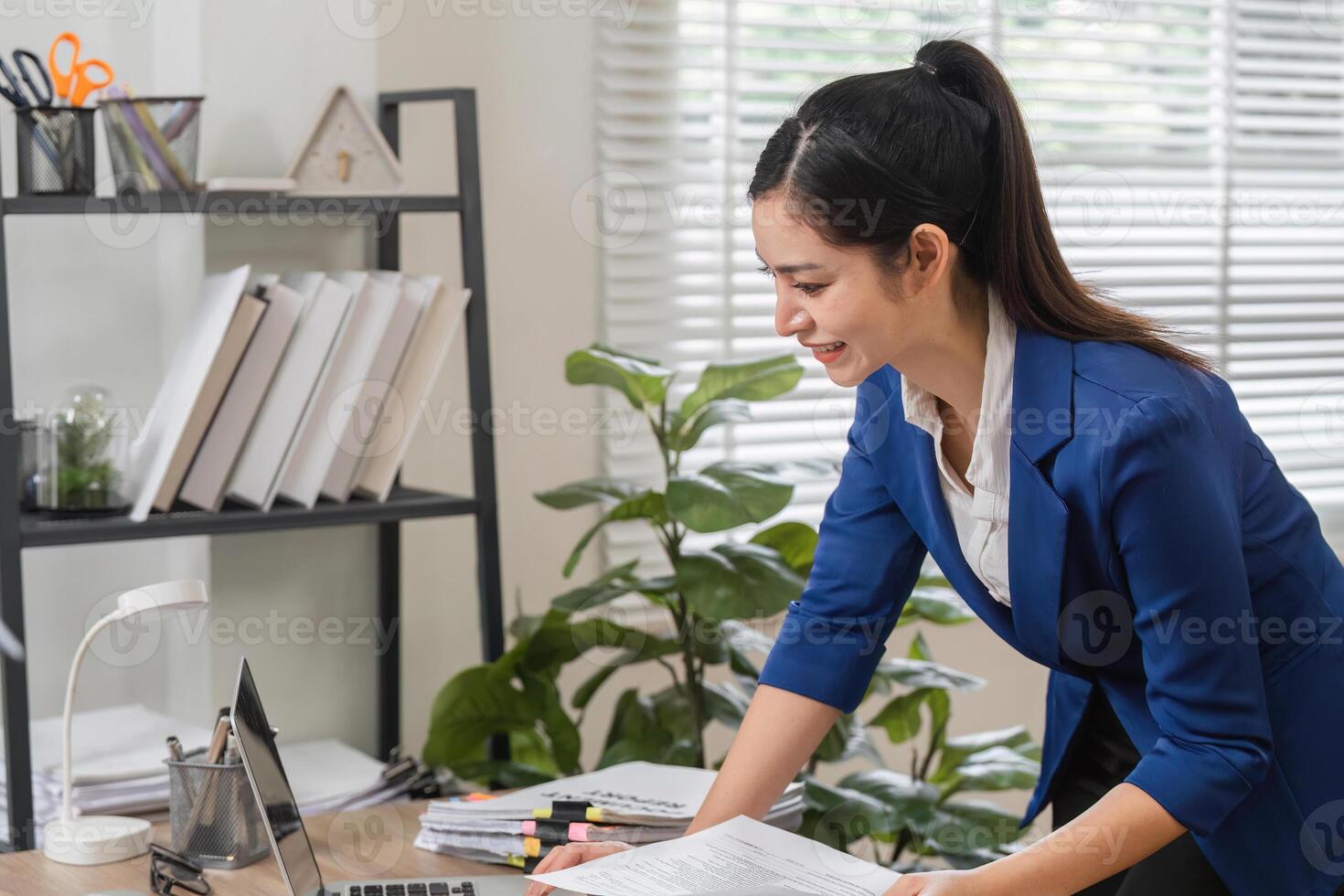 Professional accountant organizing tax documents at a modern office desk. photo