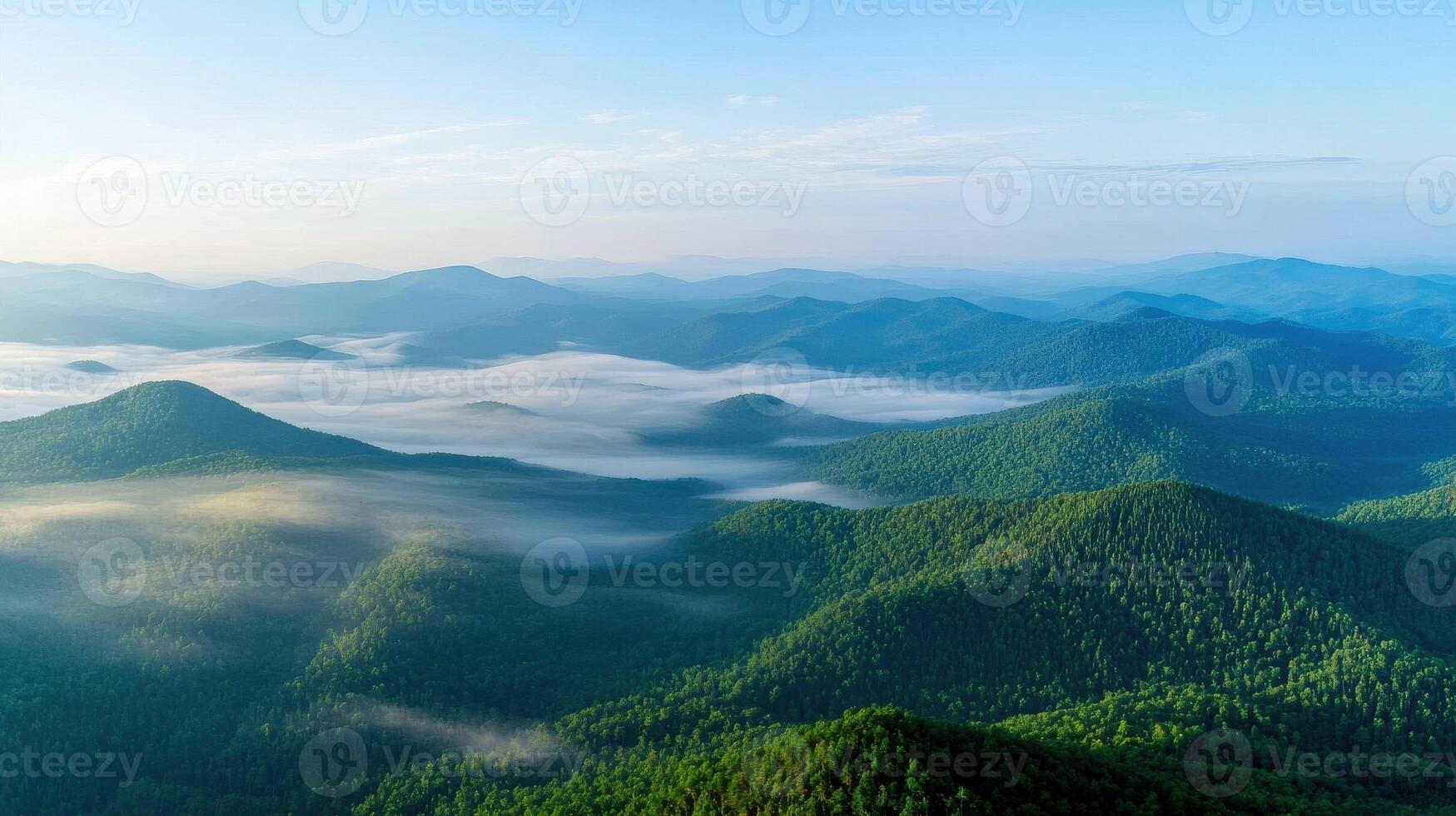 Aerial view of misty mountain ranges with dense forest and morning sky photo