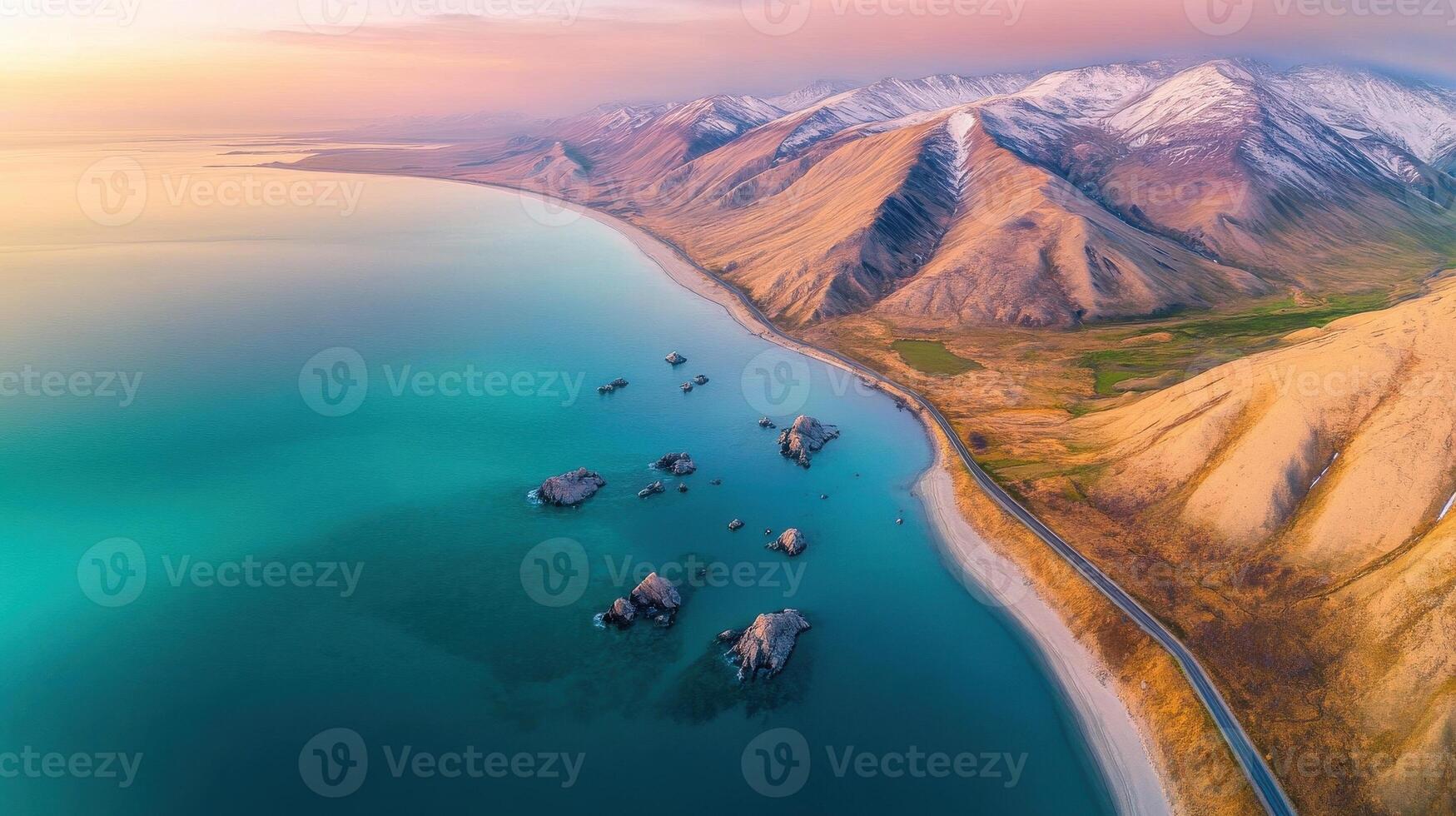 Aerial view of coastal mountain range with snow-capped peaks and turquoise waters photo