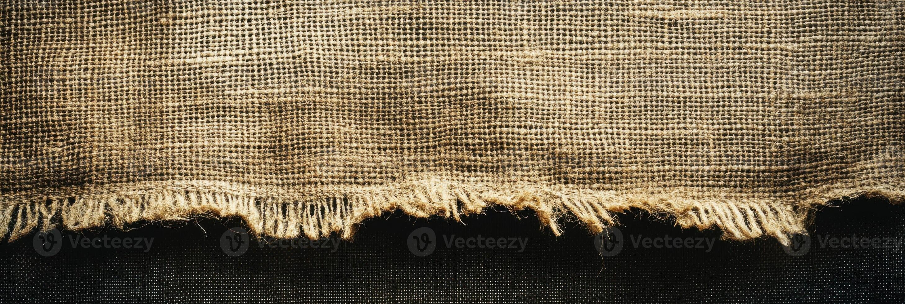 Rough textured burlap fabric with frayed edges in rustic natural tones photo
