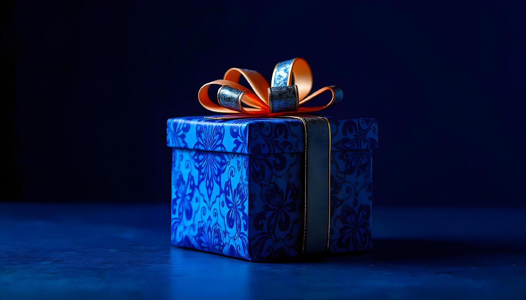 Blue gift box with orange ribbon on dark background photo