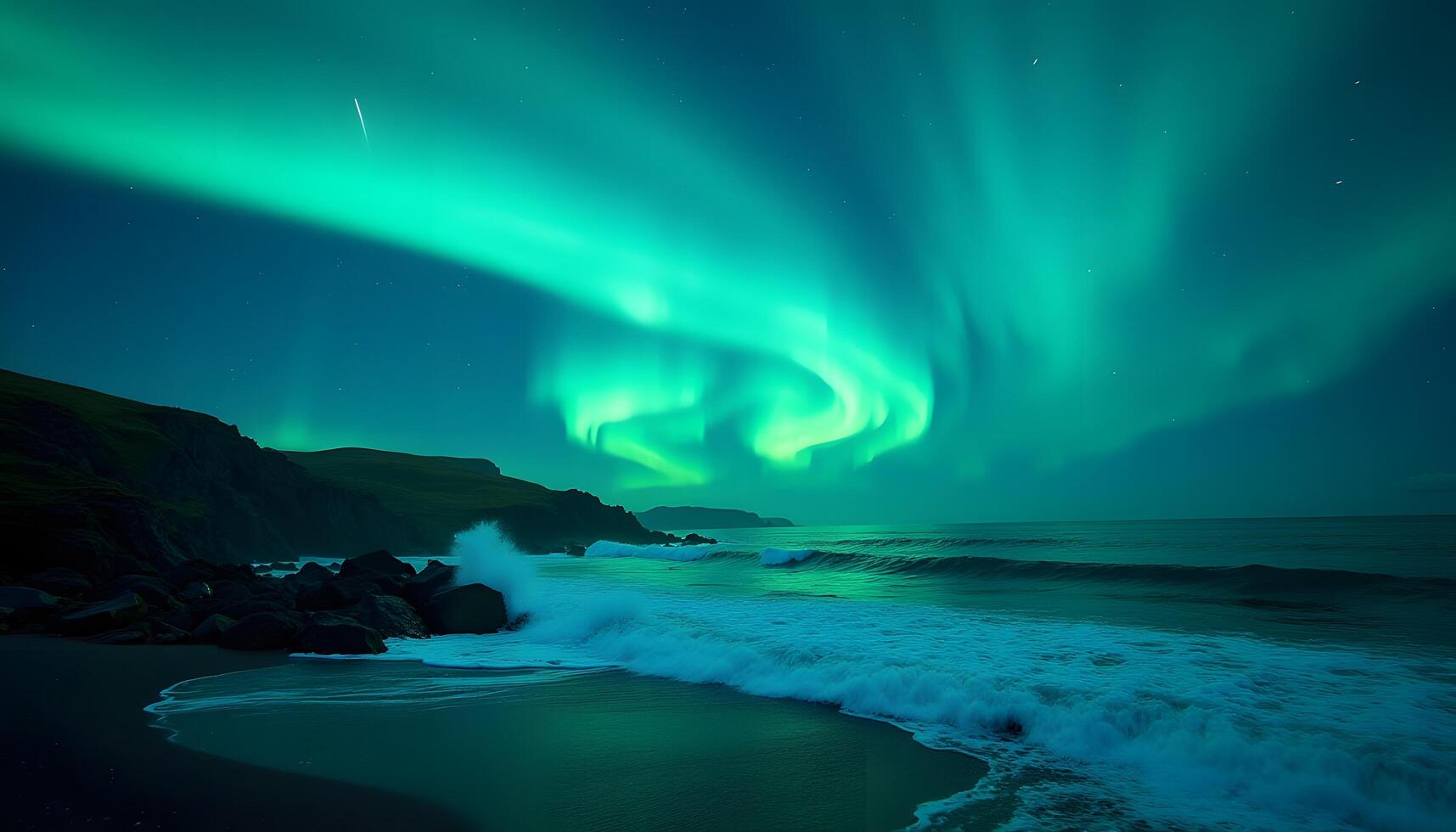 The aurora borealis lights up the sky over the ocean photo