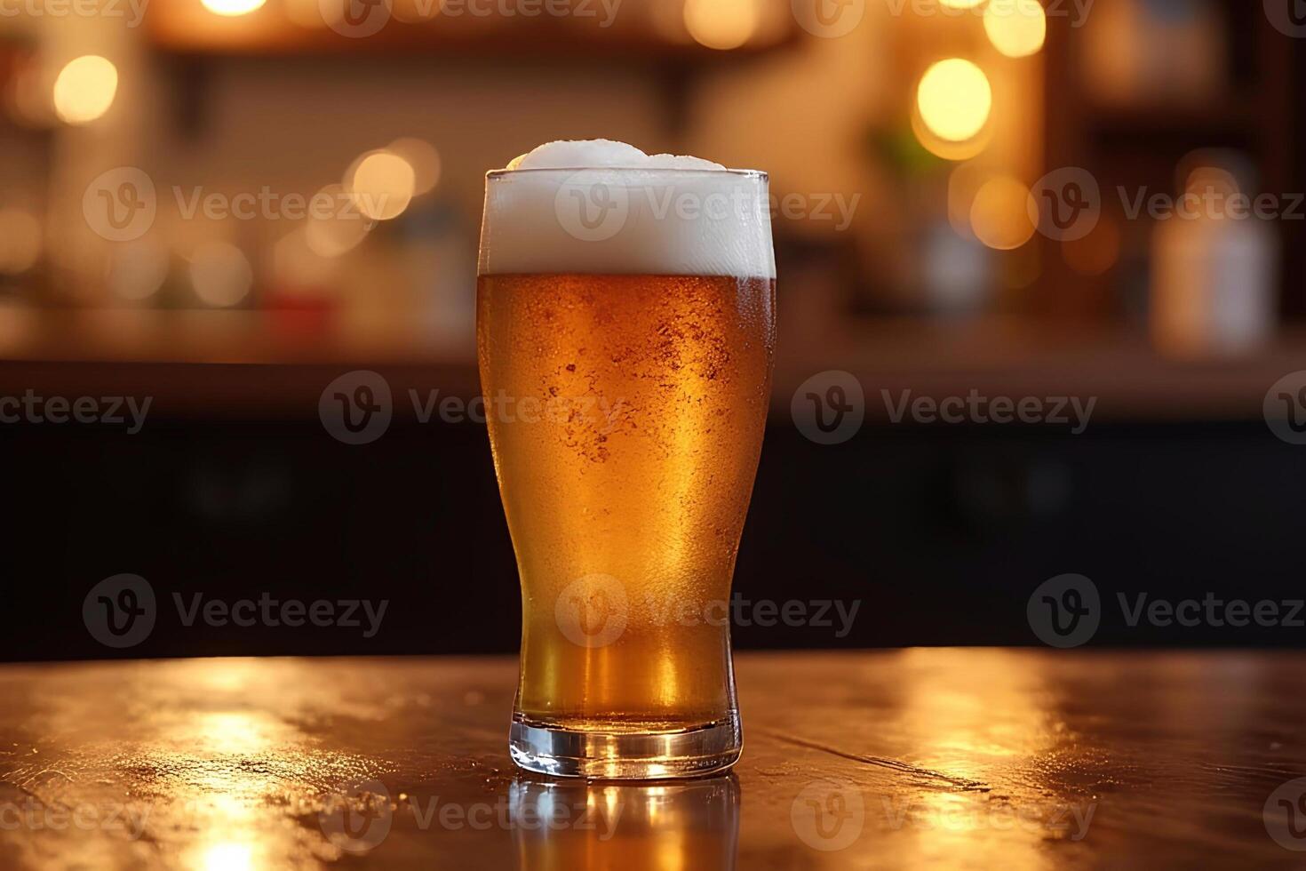 A glass of cool beer on the table photo