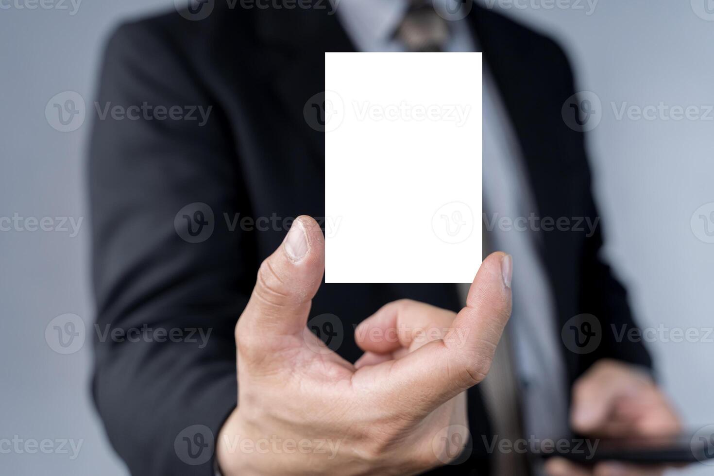 Businessman hand holding blank white business card with copy space for text photo