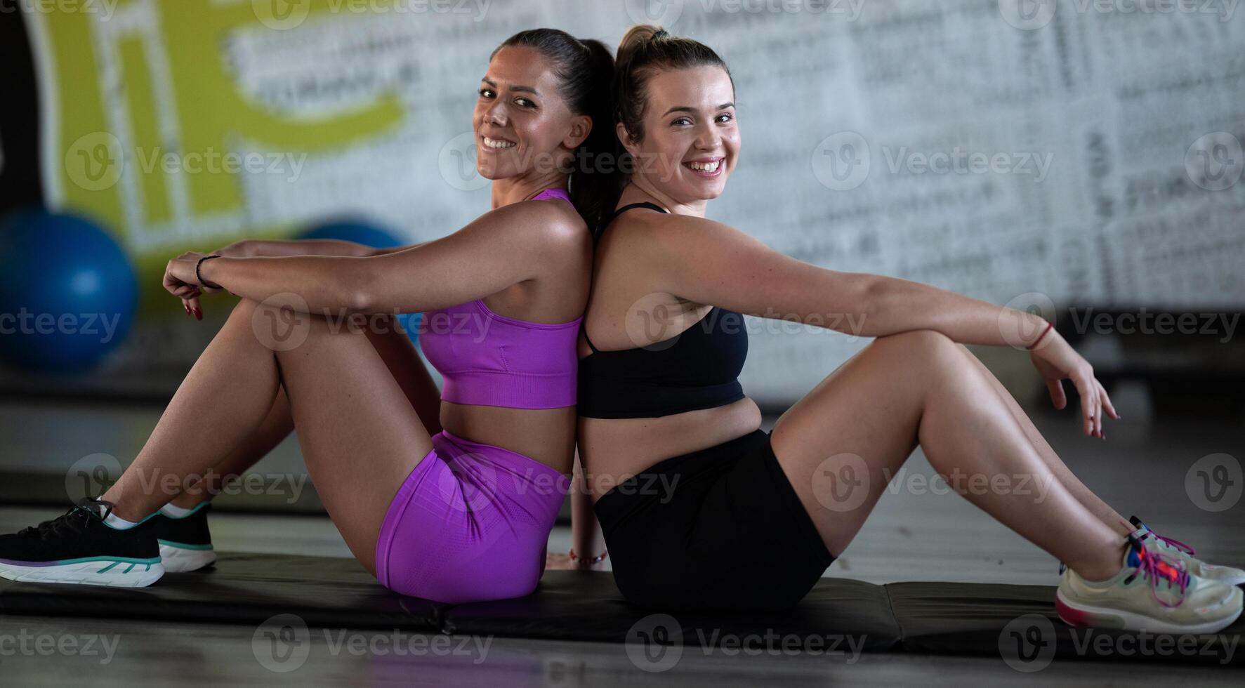 Two fitness women resting and recovering in the gym after an intense workout session, showcasing strength, endurance, and dedication to their fitness journey. photo