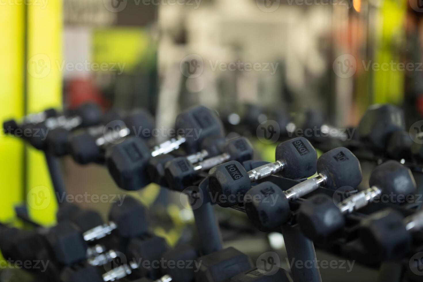 A pair of dumbbells neatly arranged in the gym, ready for a powerful workout session to build strength and endurance photo