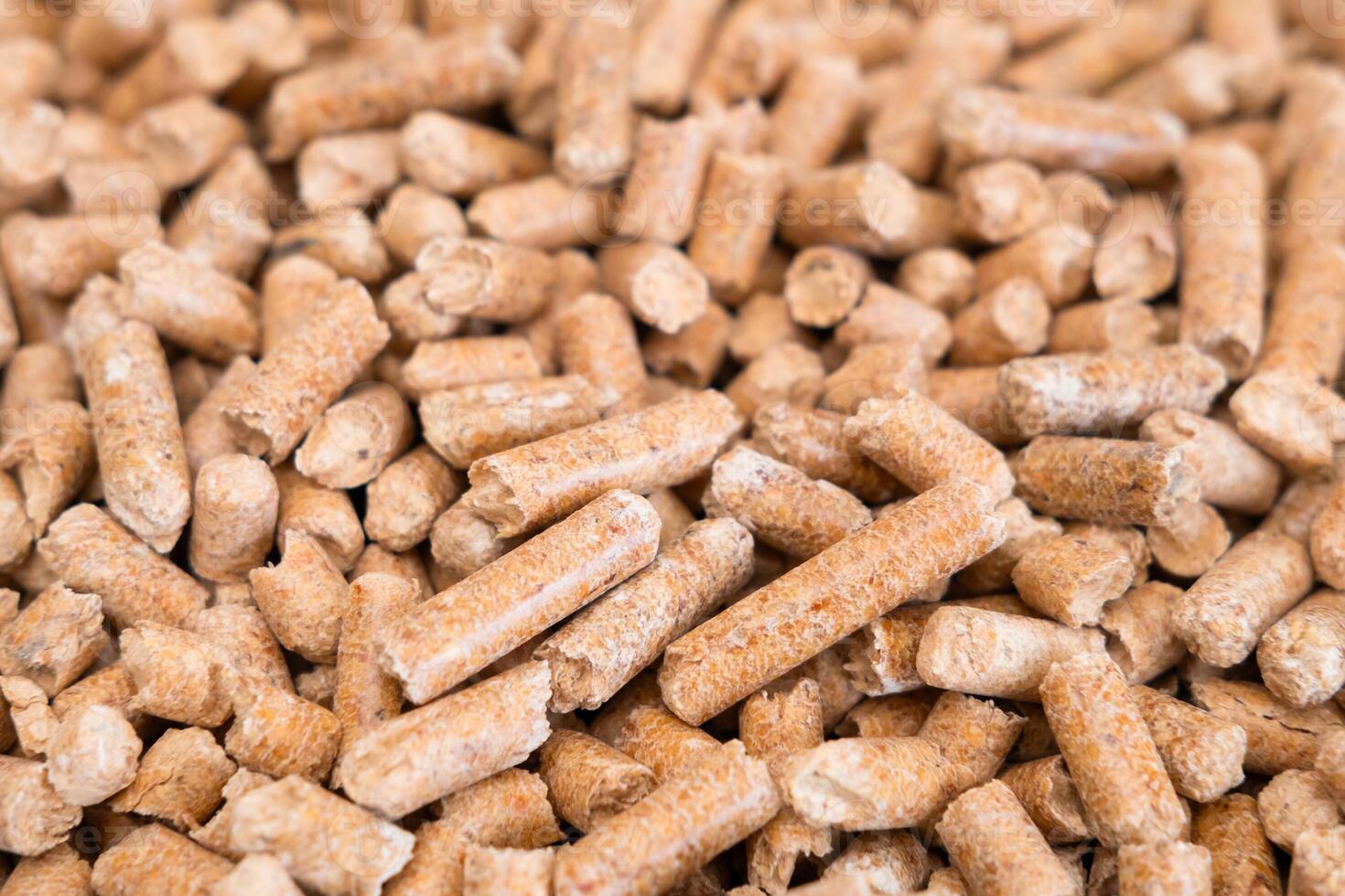 Wooden cat litter, top view. Hygienic litter for pets. Wood pellet cat litter as a background, close-up. Pressed wood, large granules. Pellets. Pile of wood pellets photo
