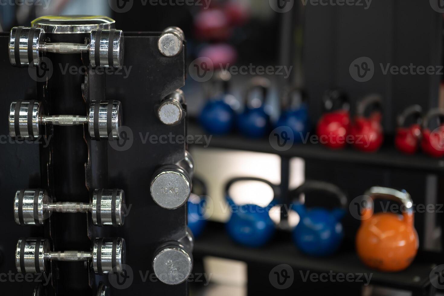 A pair of dumbbells neatly arranged in the gym, ready for a powerful workout session to build strength and endurance photo