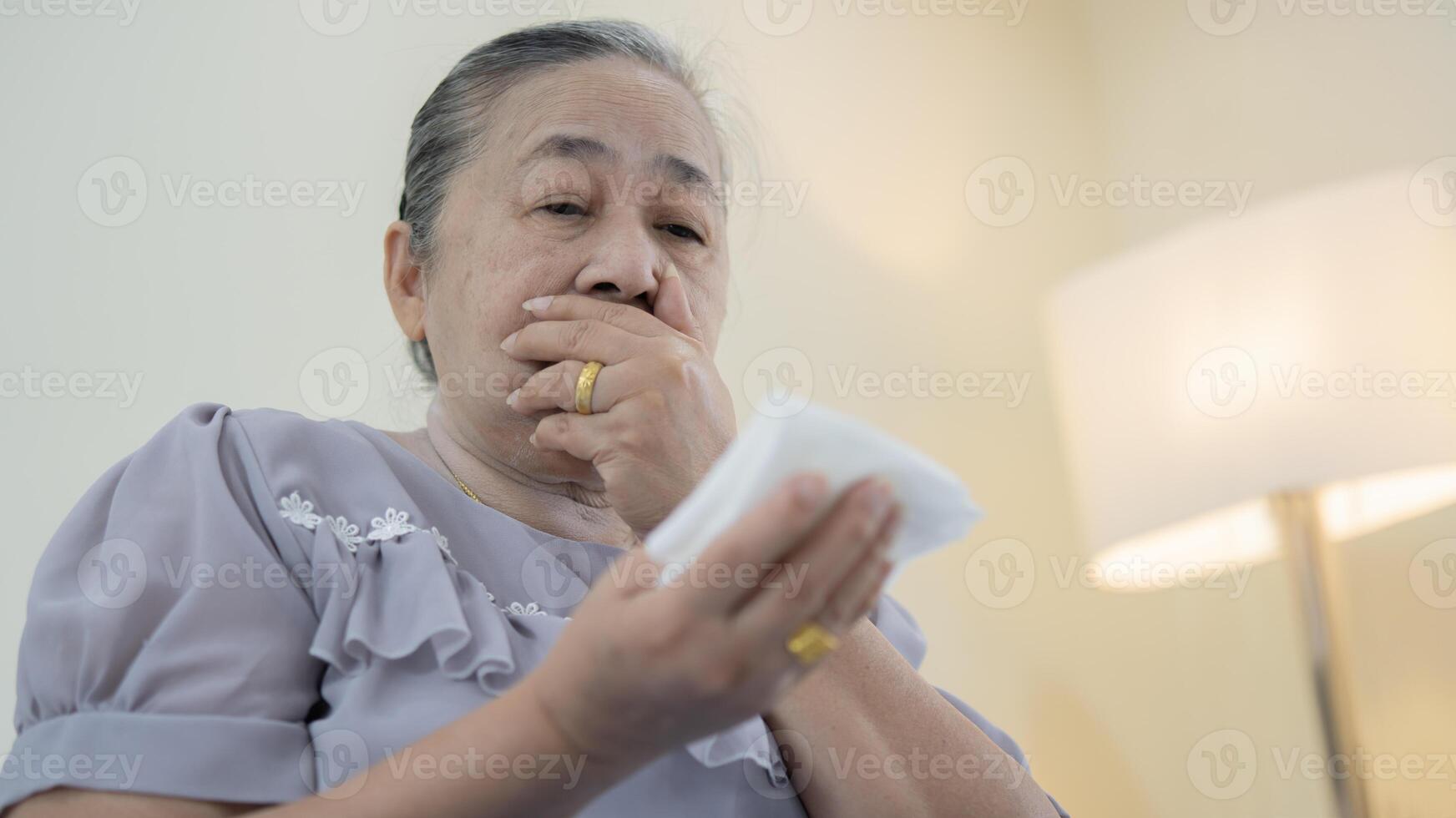 Patient suffering from pneumonia and coughing at risk of lung cancer is shocked to see bloody sputum. photo