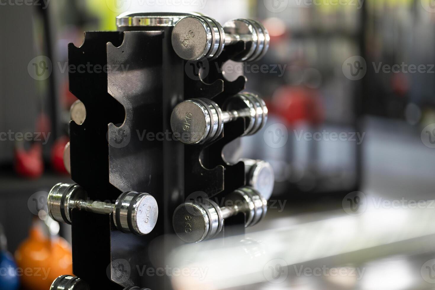 A pair of dumbbells neatly arranged in the gym, ready for a powerful workout session to build strength and endurance photo