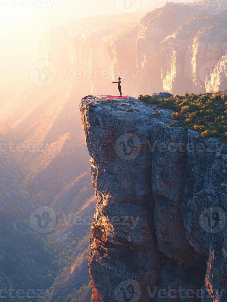 A man standing on top of a cliff with a red flag photo