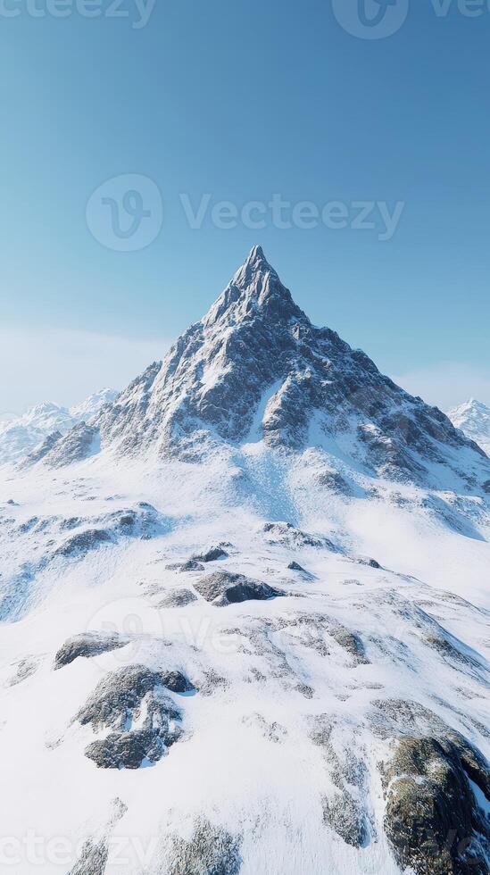 Mountain peak surrounded by snow-covered terrain on clear day photo