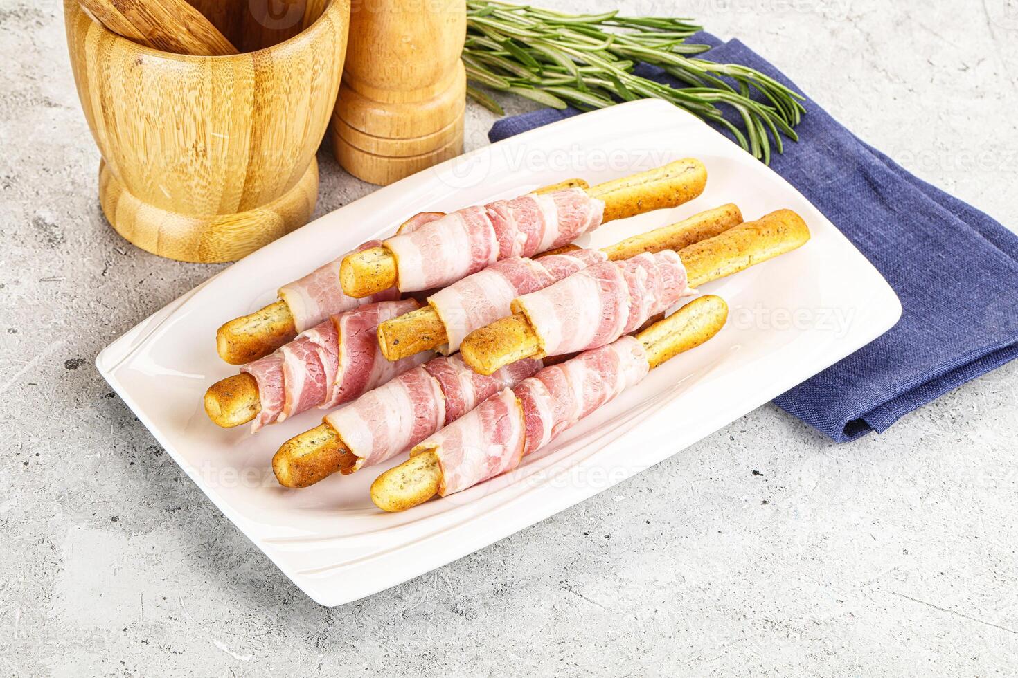A plate with bacon wrapped french toast sticks photo