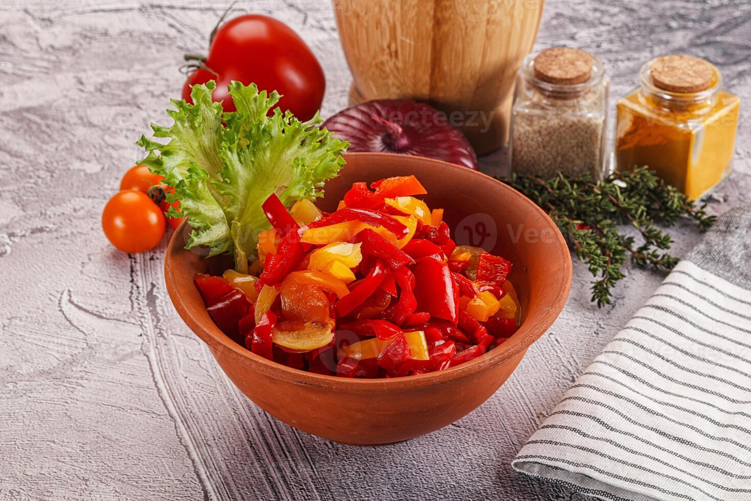 A bowl of vegetables and a wooden spoon photo