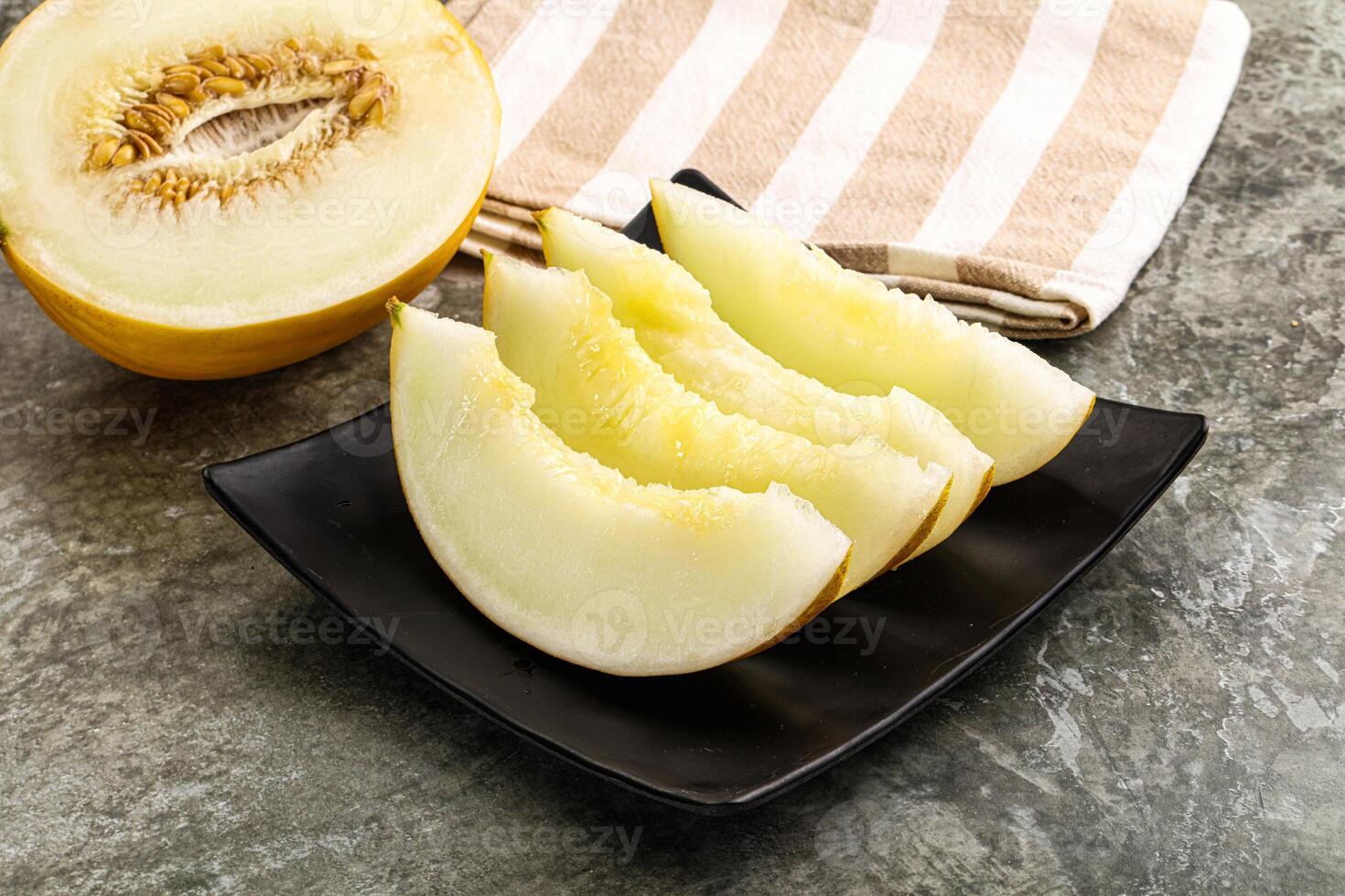 A melon on a plate with a towel on it photo