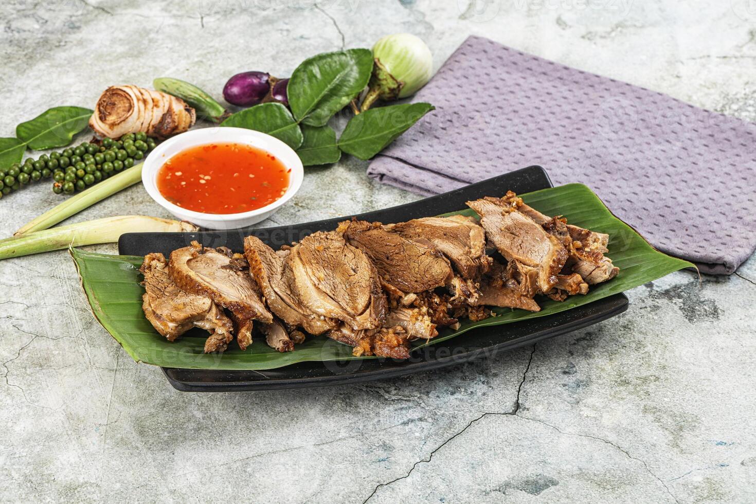 A plate with meat and sauce on it photo