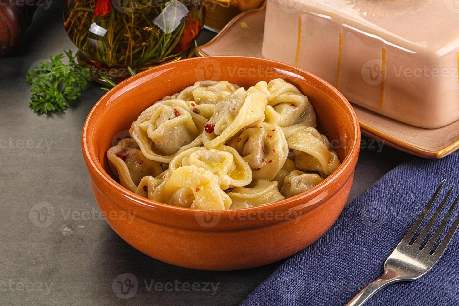 A bowl of pasta with a fork and knife photo