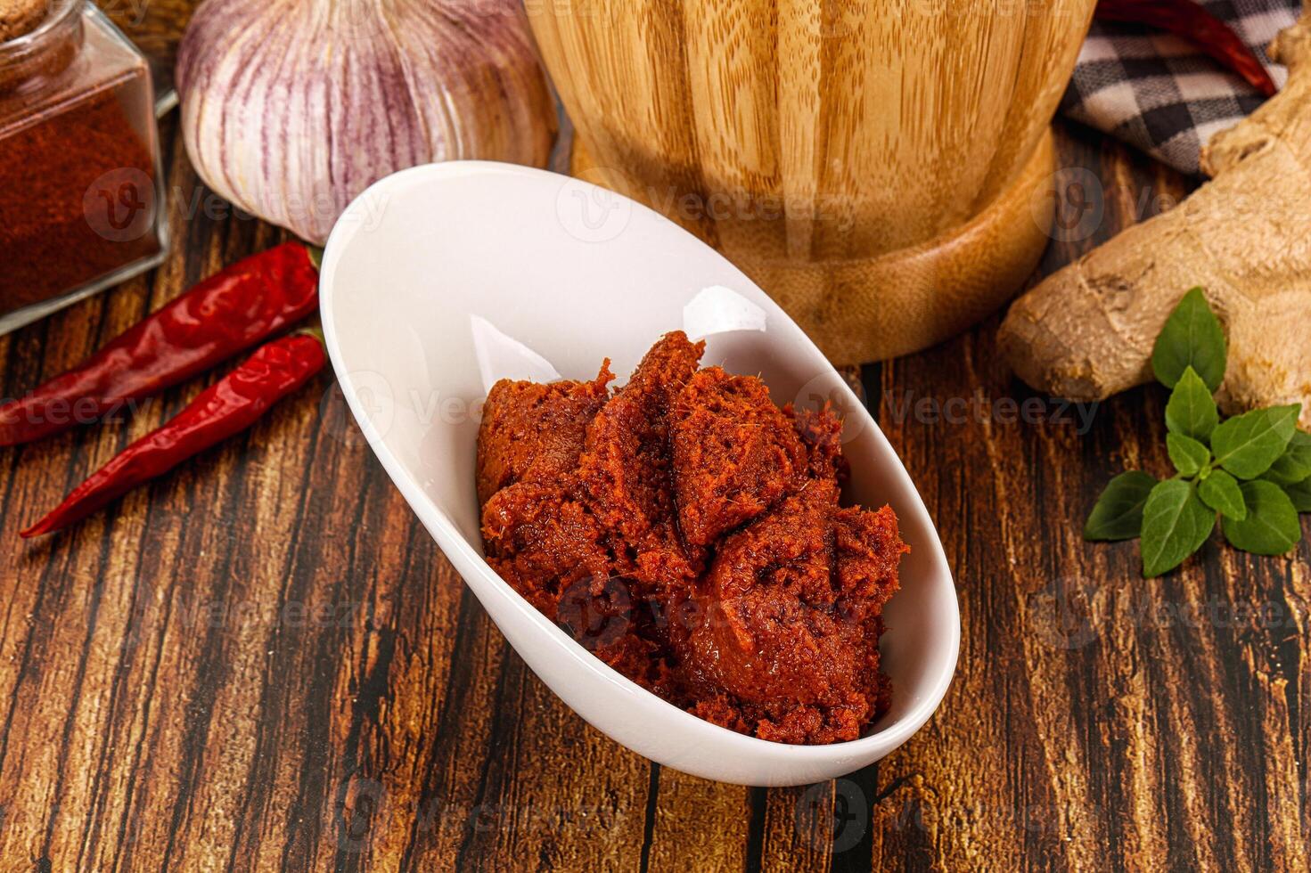 A bowl of spices and a bottle of ginger ale photo