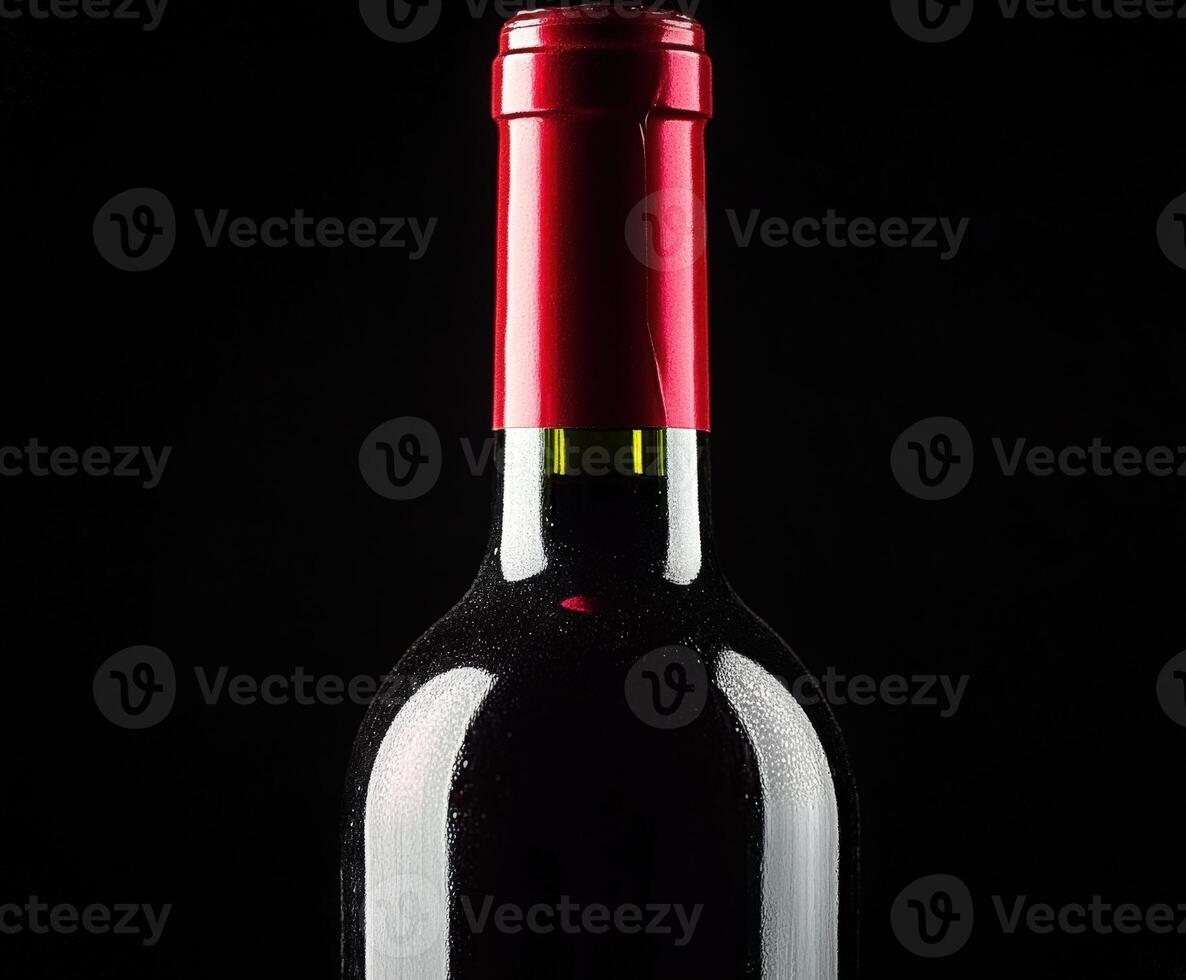 Red wine bottle with shiny cap against black background photo