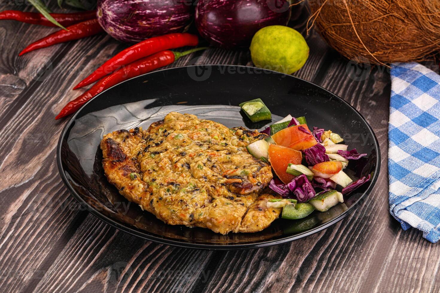 A plate of food with vegetables and a coconut photo