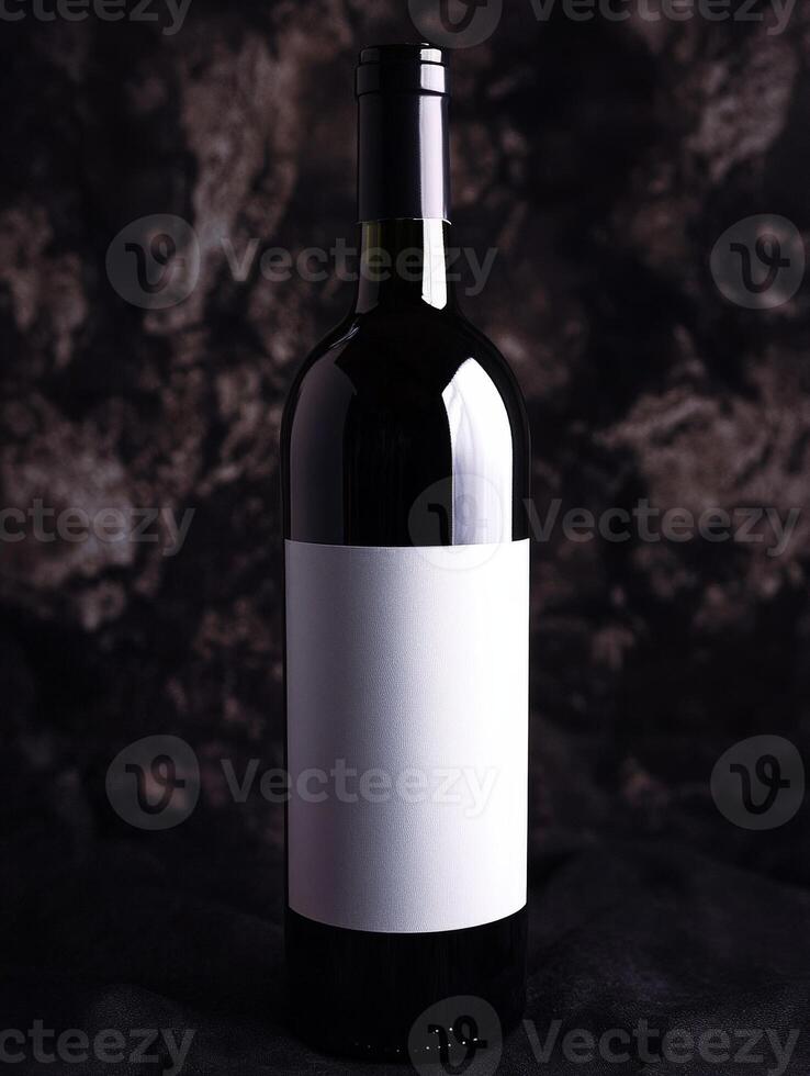 Elegant red wine bottle on dark textured background photo