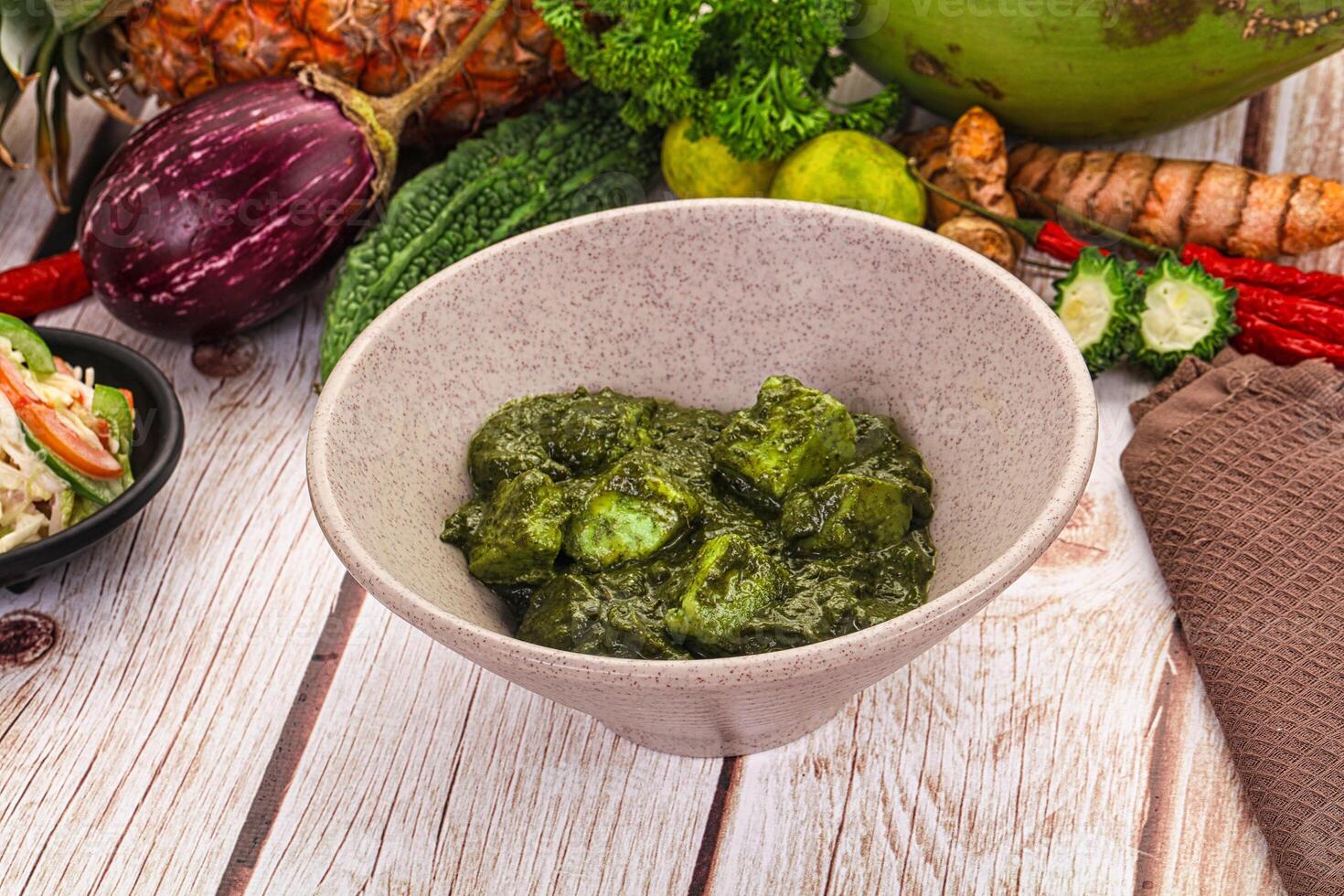 A bowl of green food on a table photo
