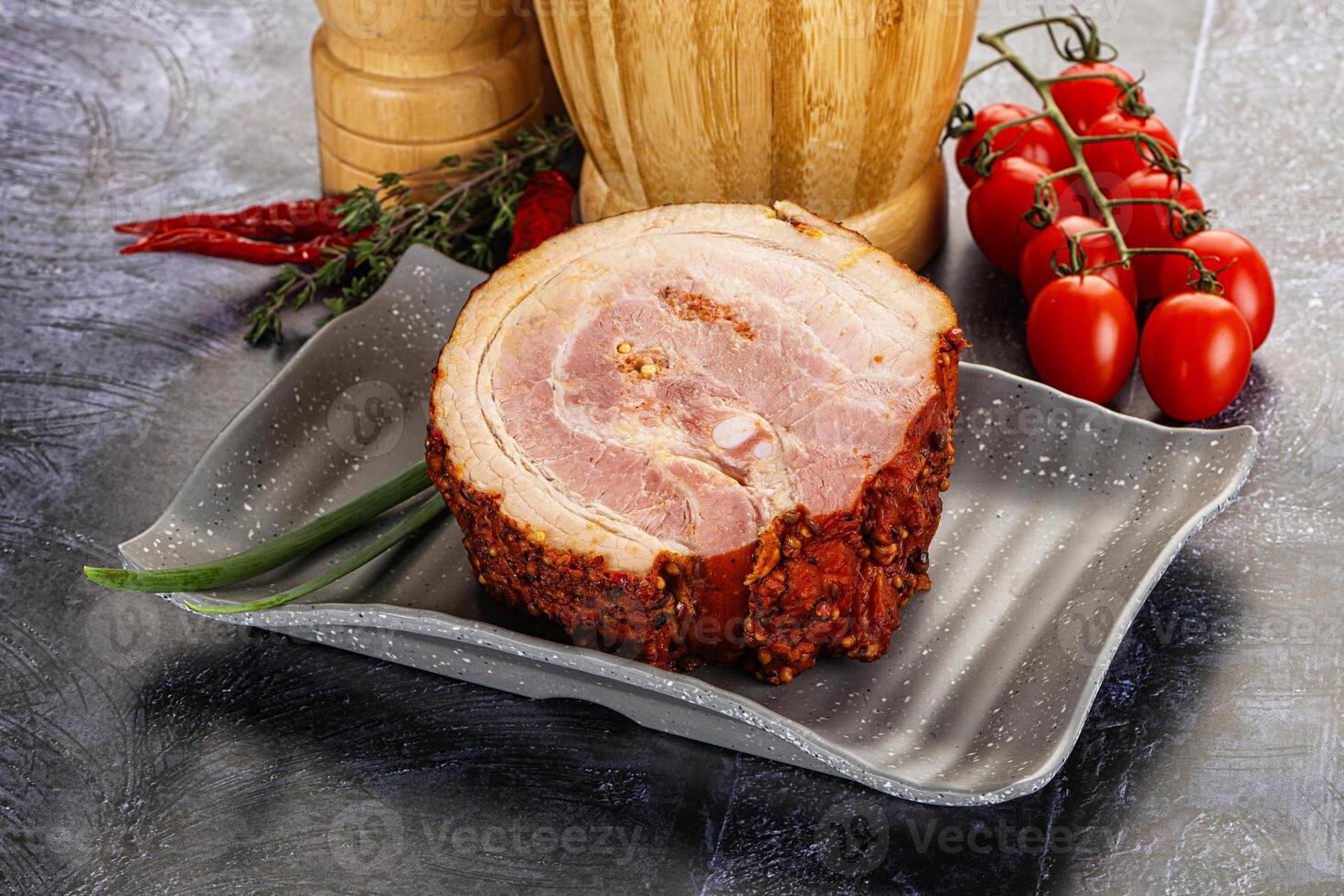 A plate with a ham on it and a bottle of wine photo