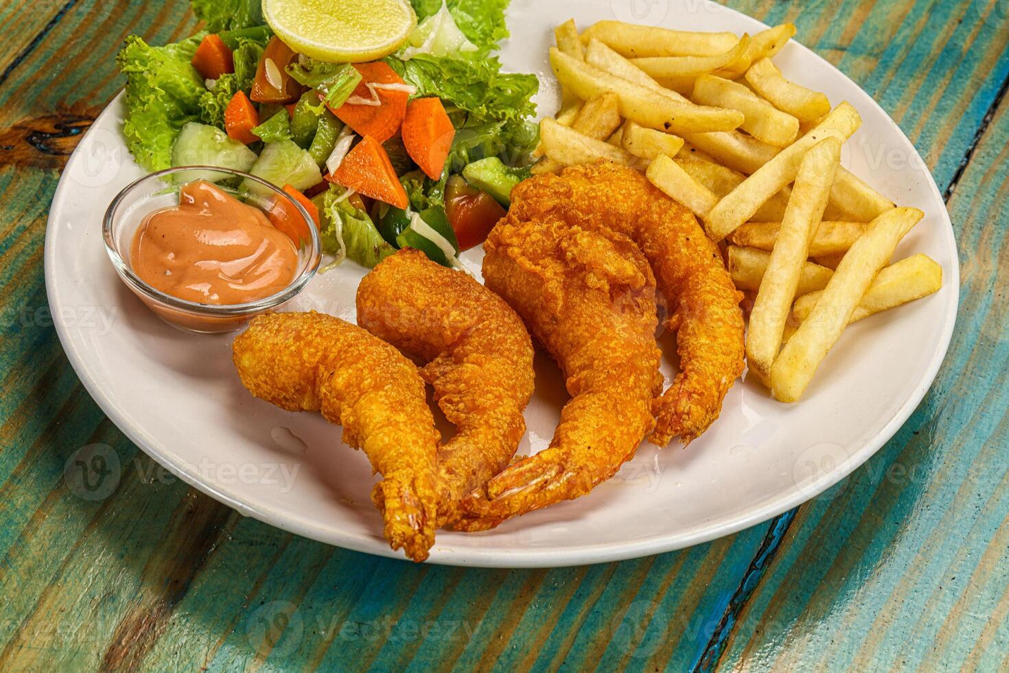 A plate of food on a wooden table photo