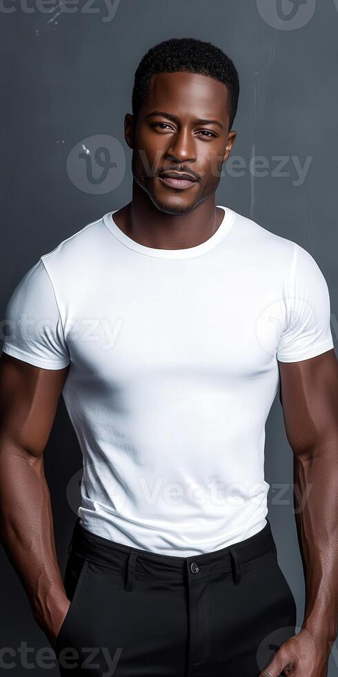 Stylish man posing in a fitted white shirt and black pants photo
