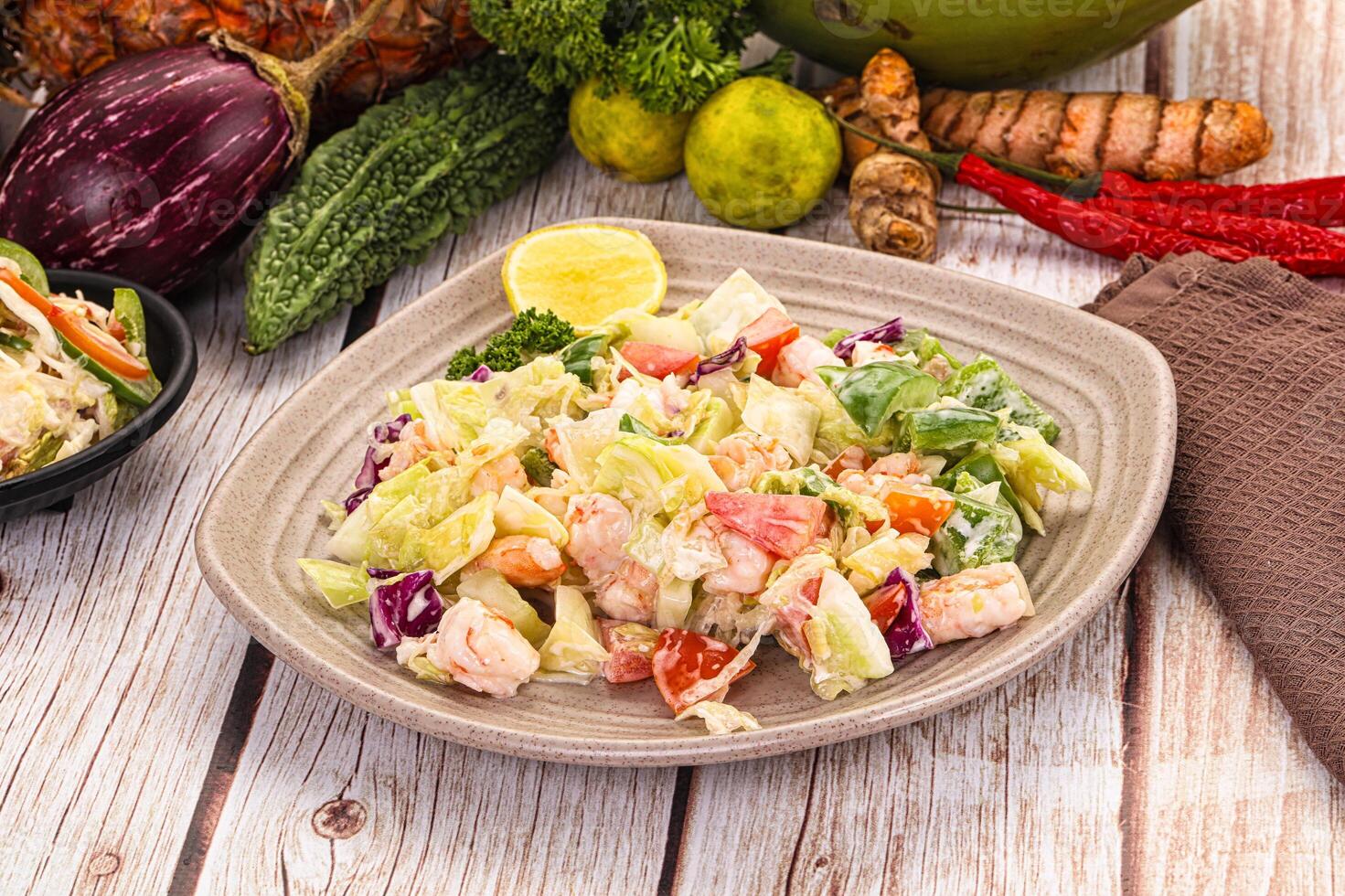 A plate of food on a table with a bowl of fruit photo