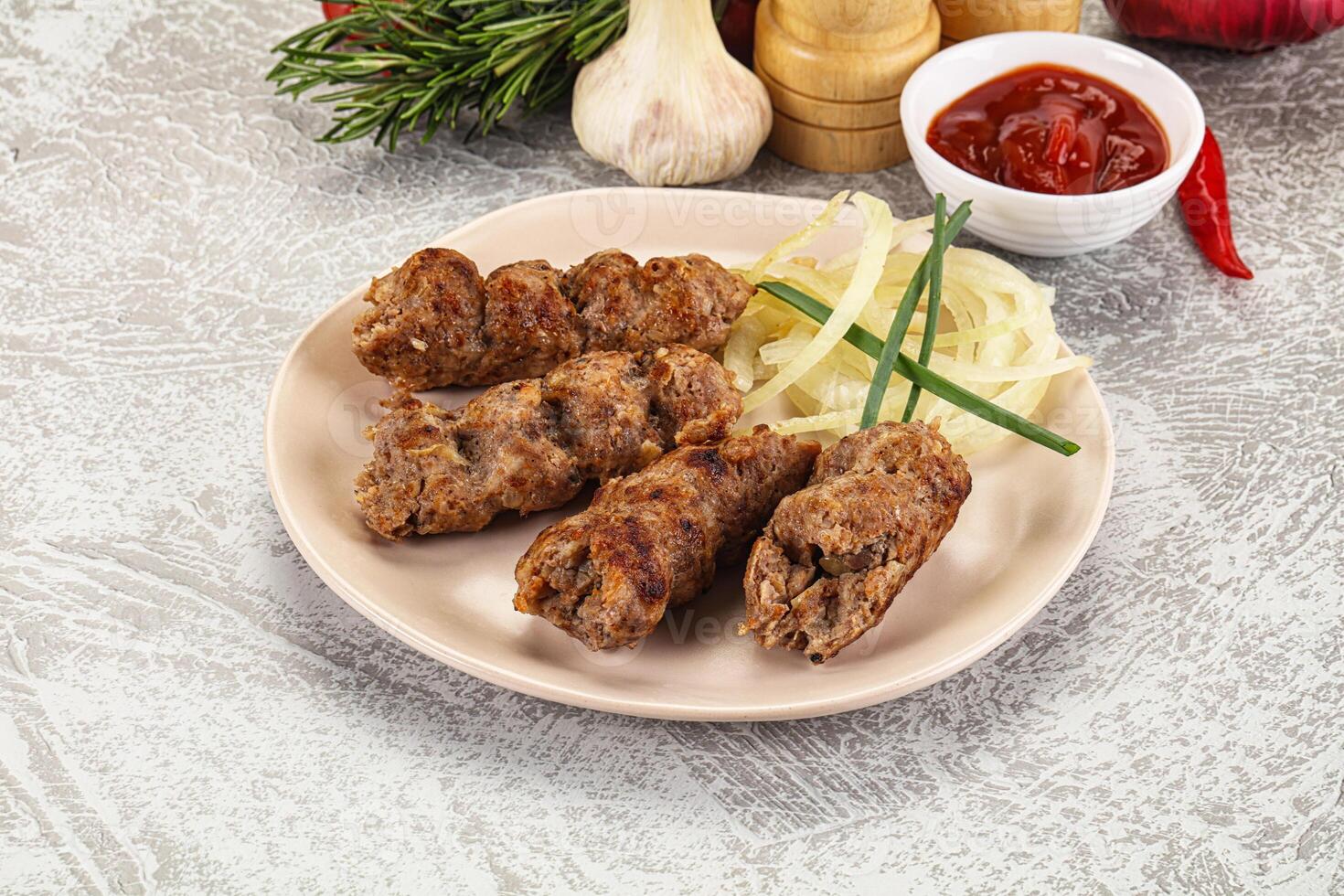 A plate with meat on it and some vegetables photo