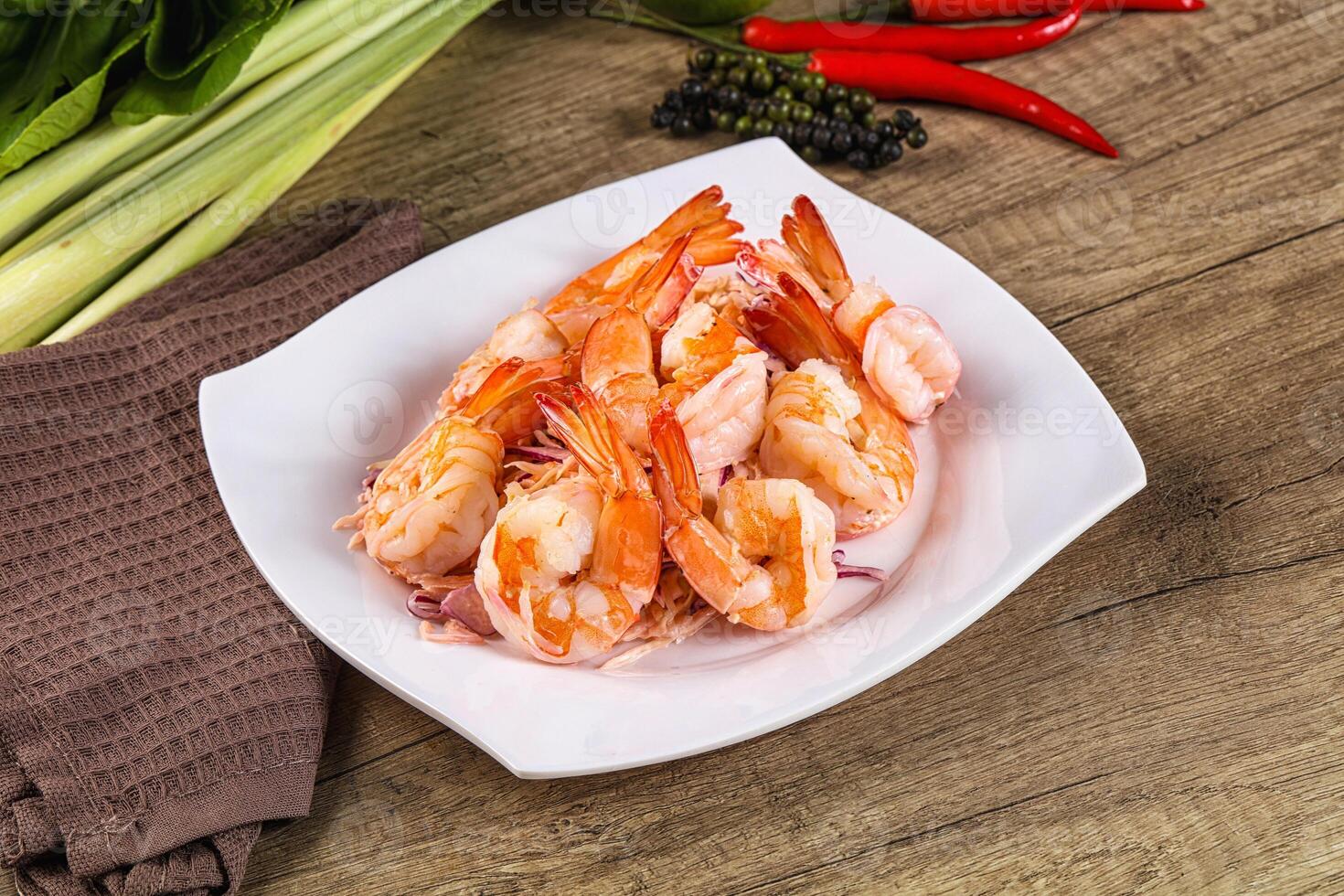 A white plate with shrimp and vegetables photo