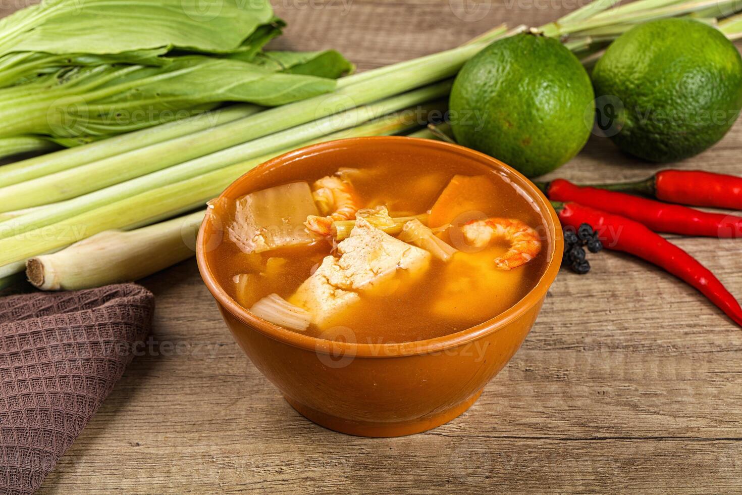 A bowl of soup with a green pepper and lime photo