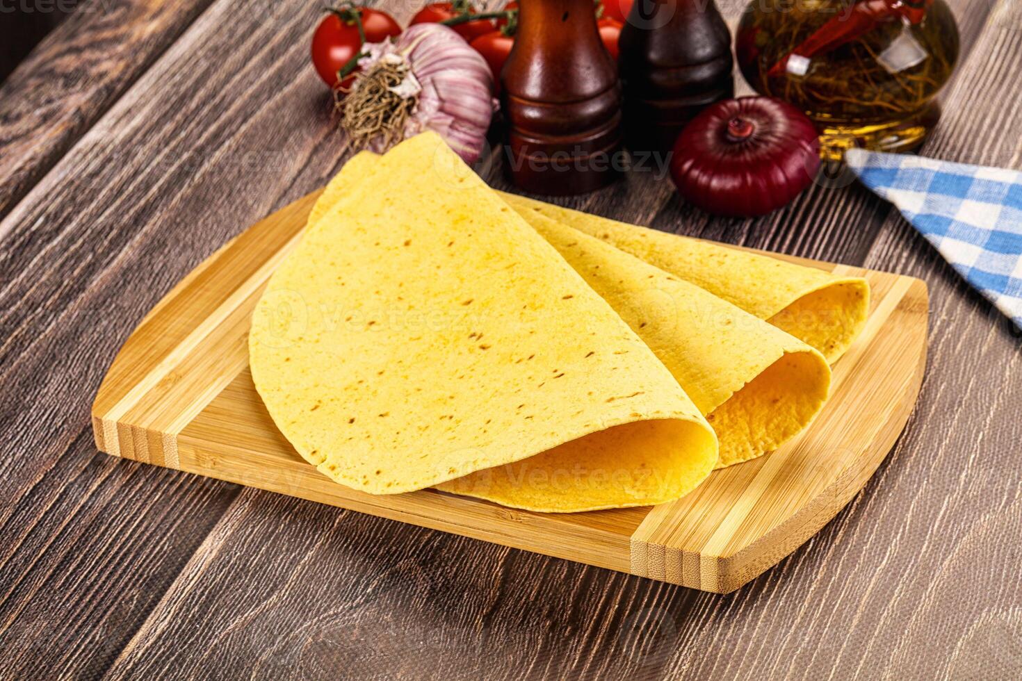 A tortilla on a wooden cutting board photo