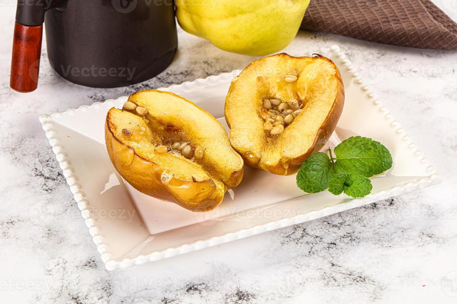 A white plate topped with two halves of an apple photo