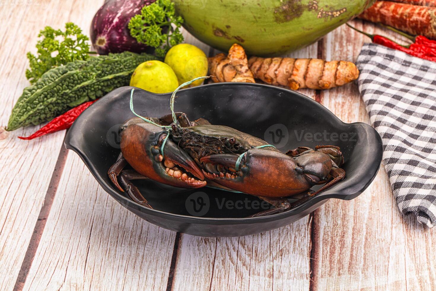 A bowl of food on a table with a lobster photo