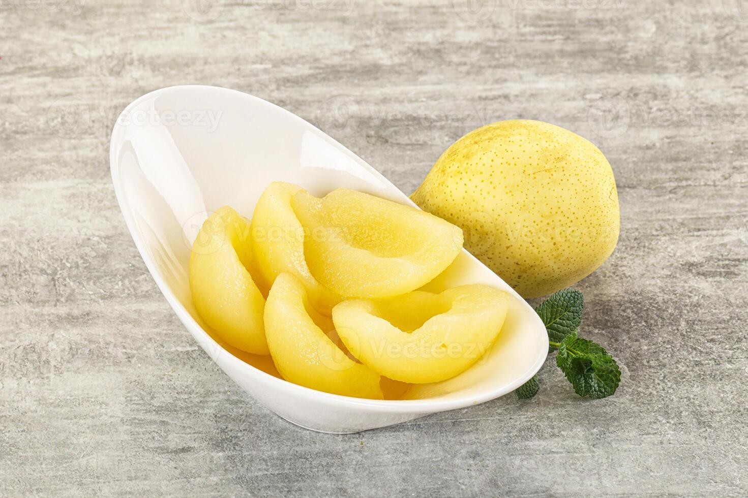 A white bowl with a lemon and a few pieces of fruit photo