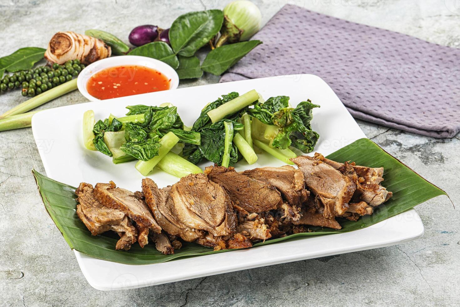 A plate of food with meat and vegetables on it photo
