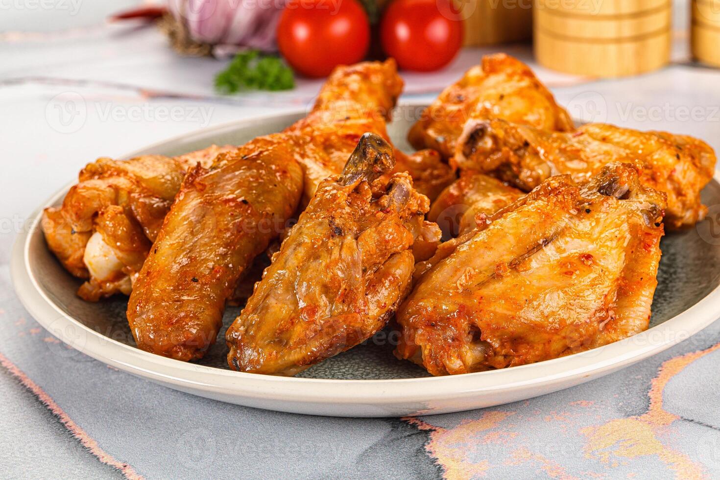 A plate of chicken wings on a table photo