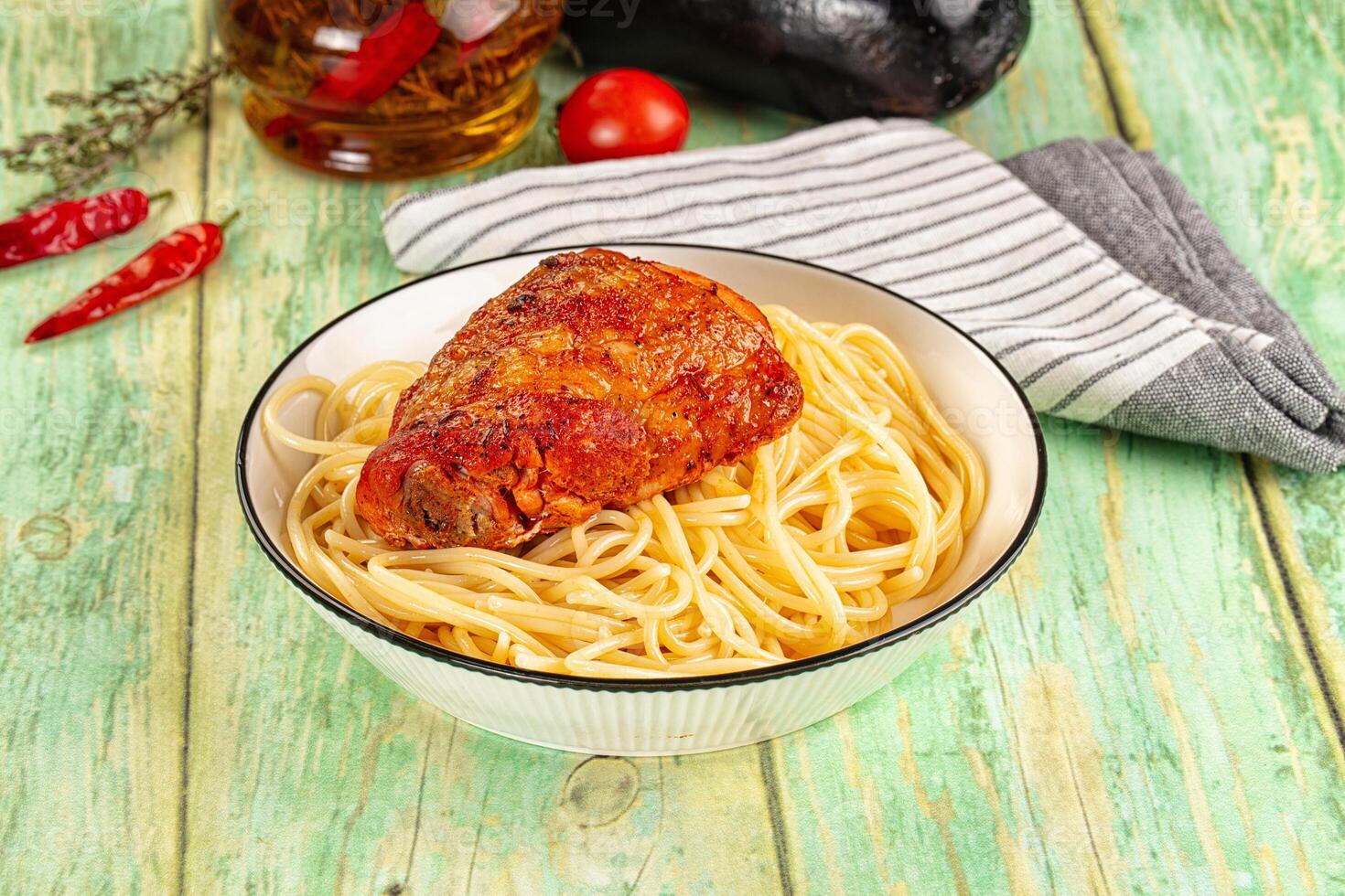 A bowl of spaghetti and meatballs on a table photo