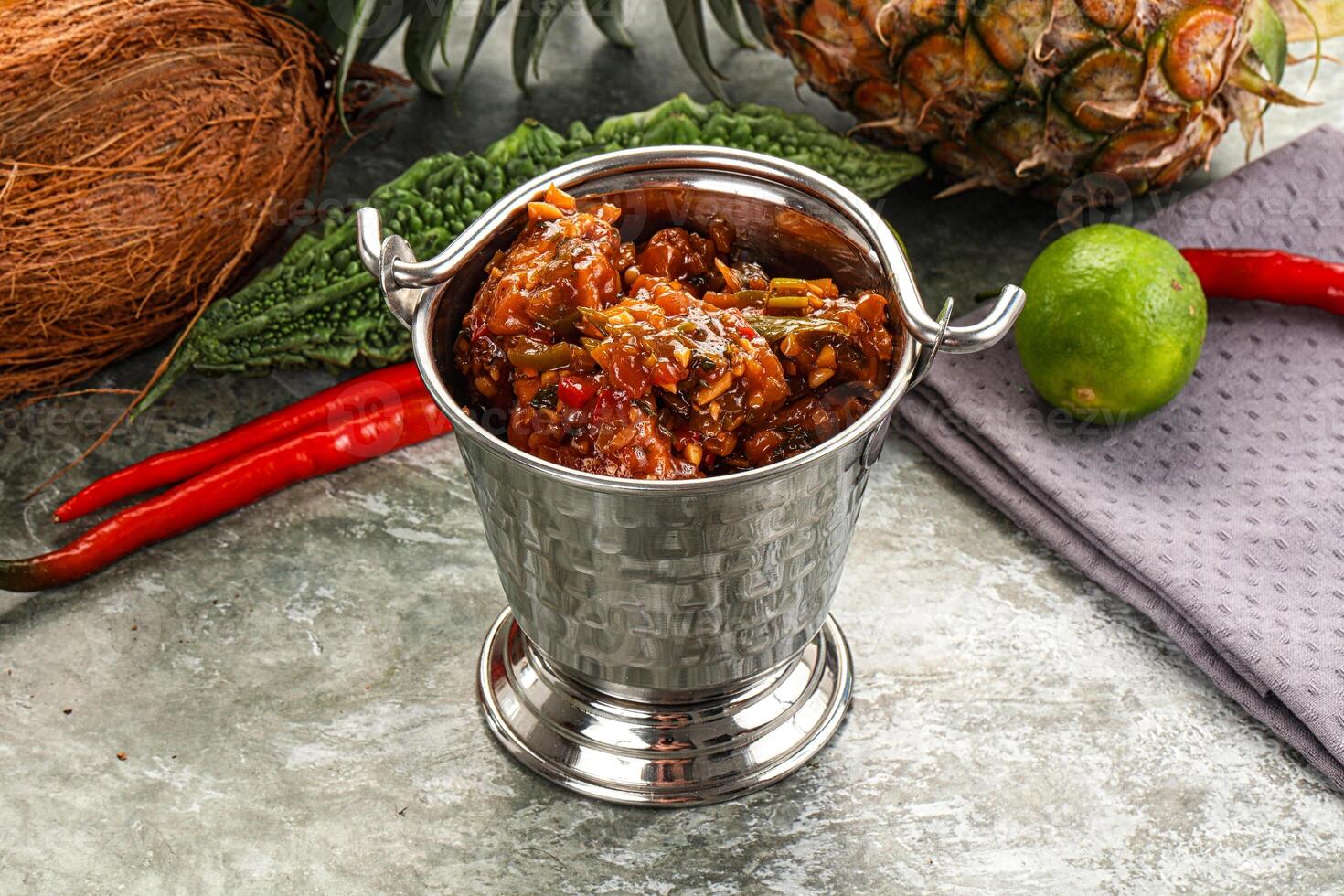A silver cup with a coconut and a pineapple photo