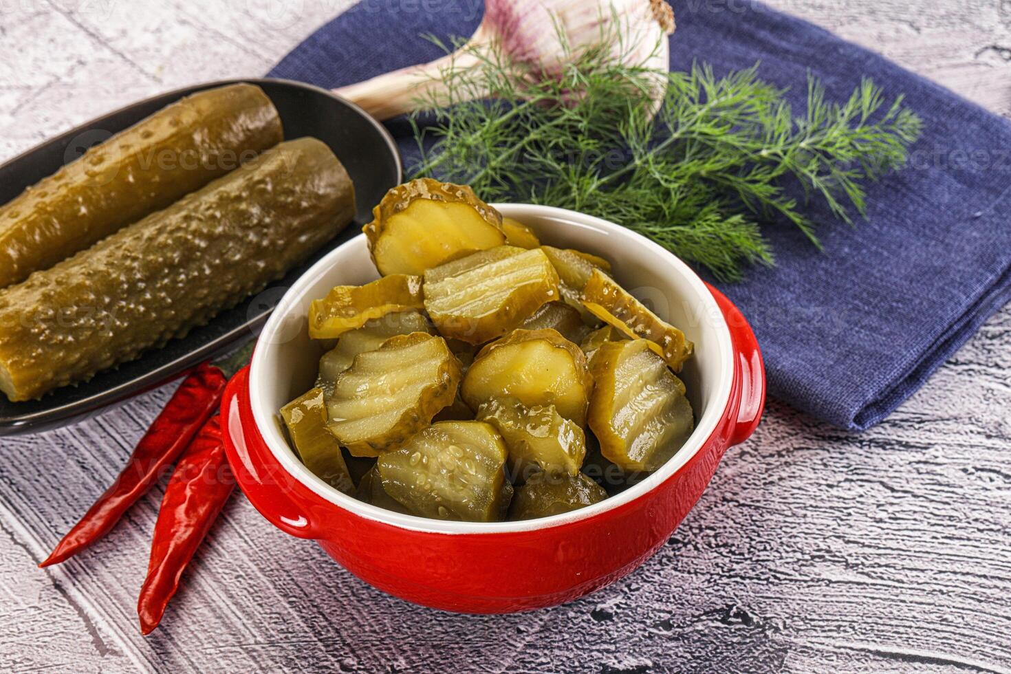 A bowl of pickles and a bowl of pickles photo