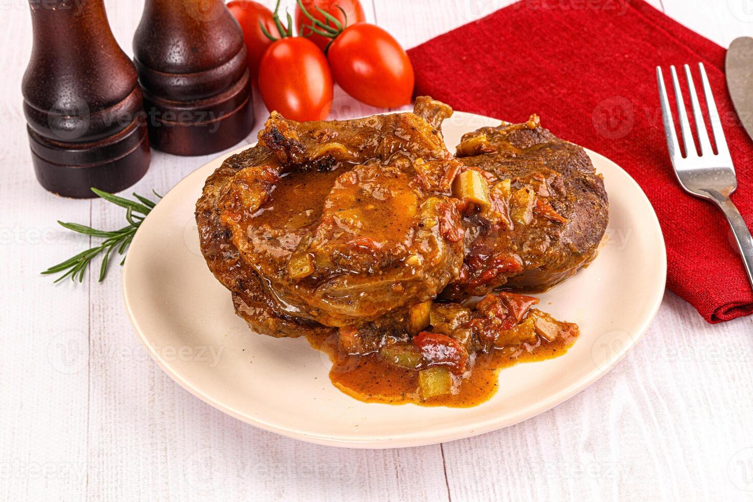 A plate of meat and vegetables on a table photo