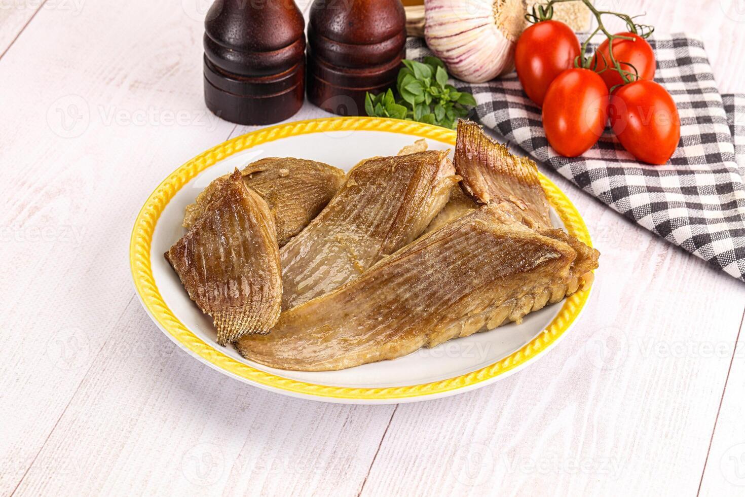 A plate of fish on a wooden table photo