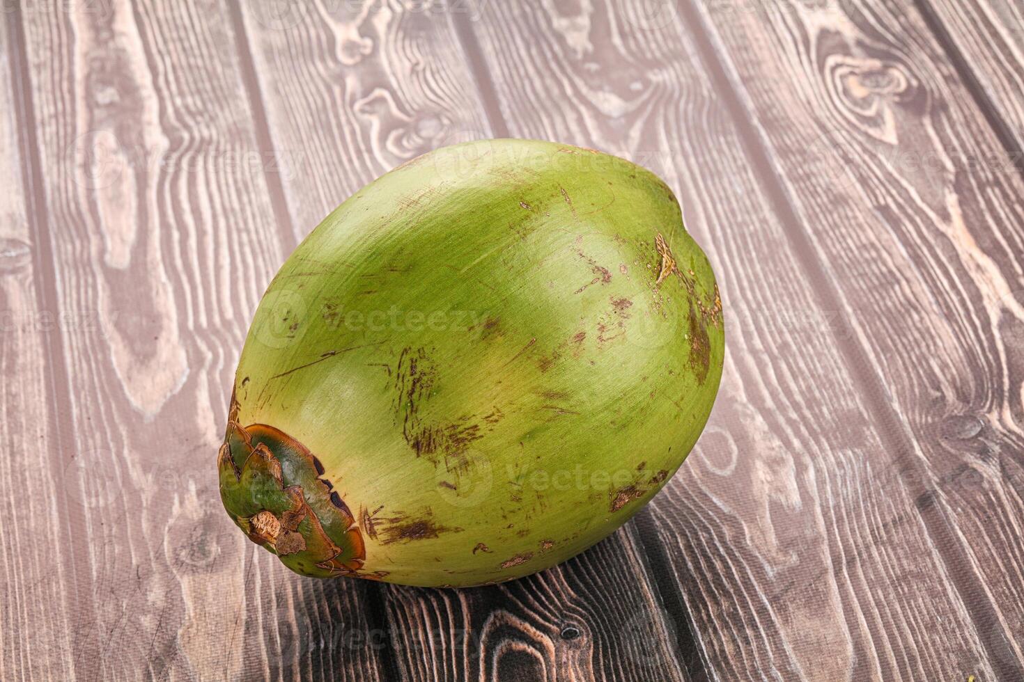 A coconut on a wooden table photo