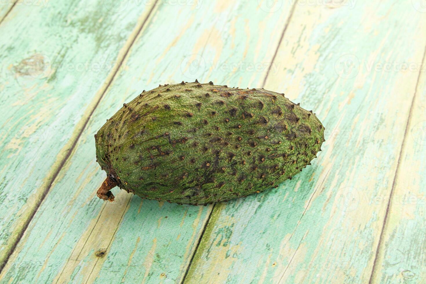 A single fruit on a wooden table photo