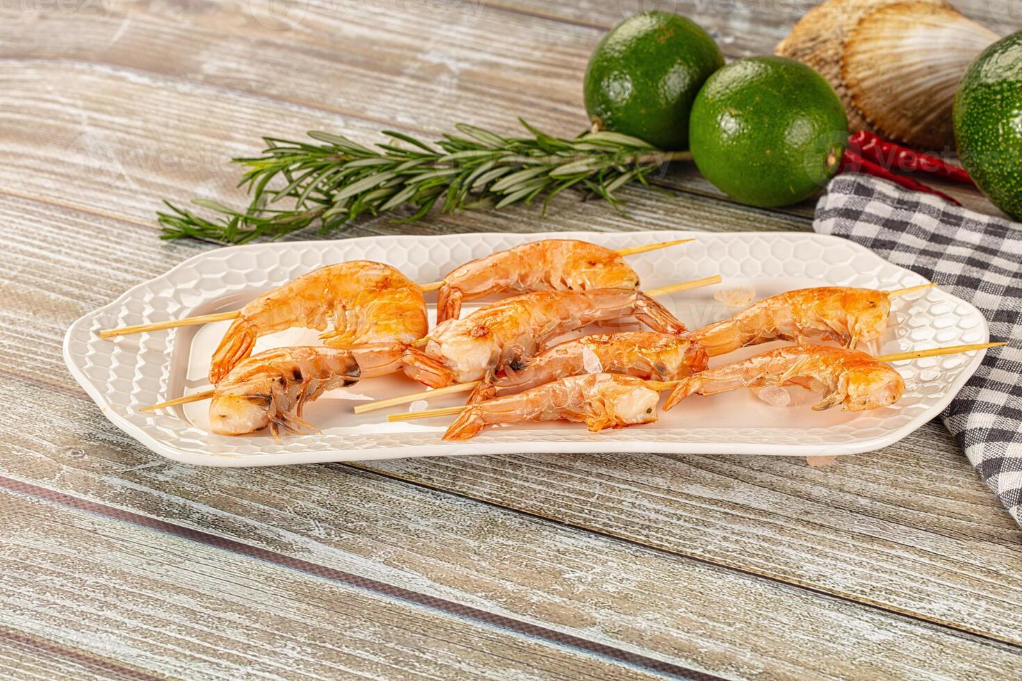 A plate with shrimp and herbs on it photo