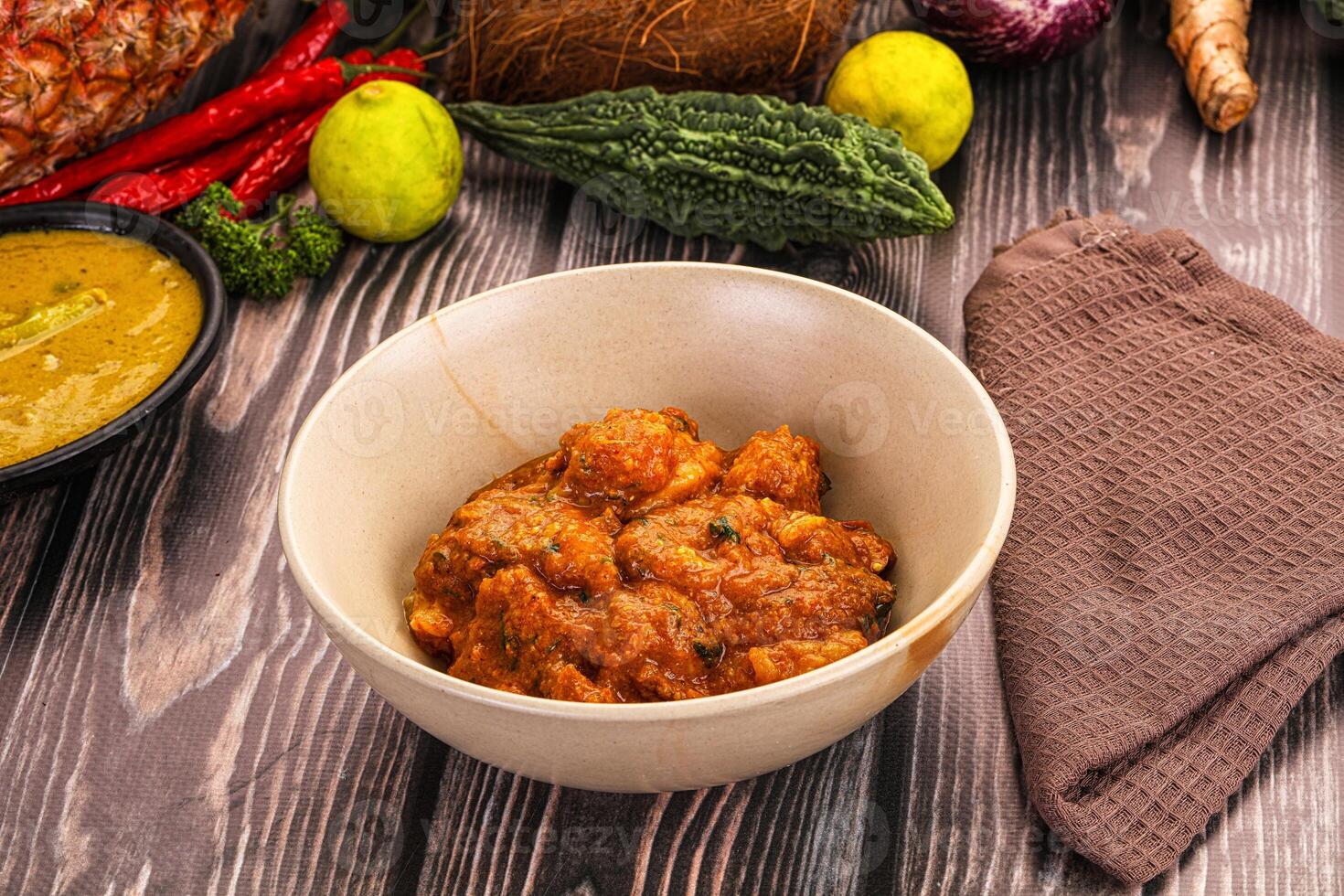 A bowl of food on a table with other food photo