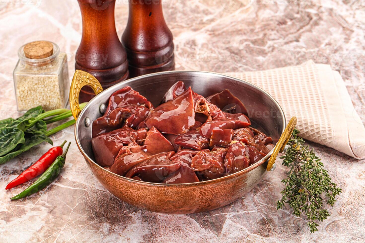A bowl of meat and spices on a marble counter photo