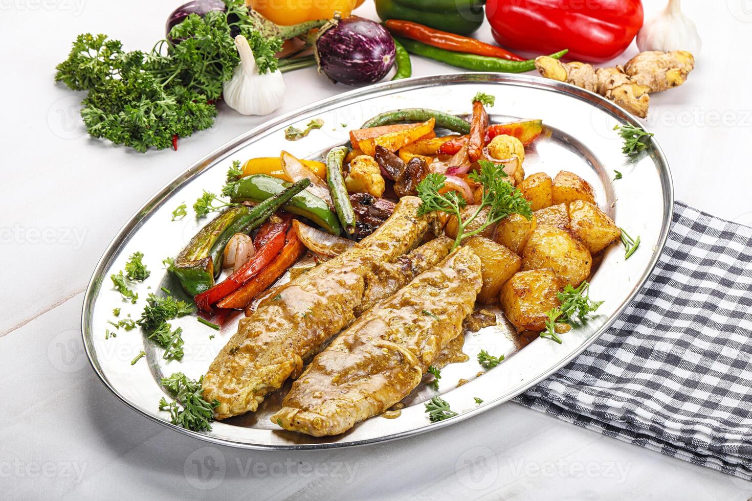 A plate of food with vegetables and meat photo